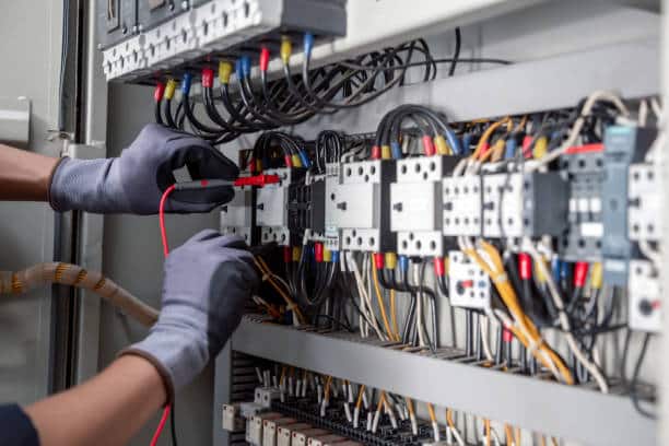 Electrician working on a control panel
